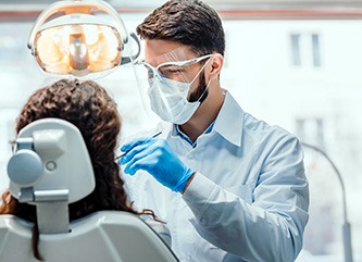 A dentist performing a dental checkup on his patient