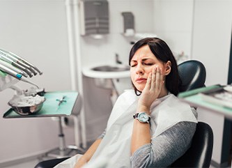 Patient experiencing dental implant pain