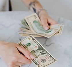 Woman’s hands counting cash