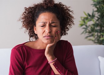 Young woman experiencing dental implant failure