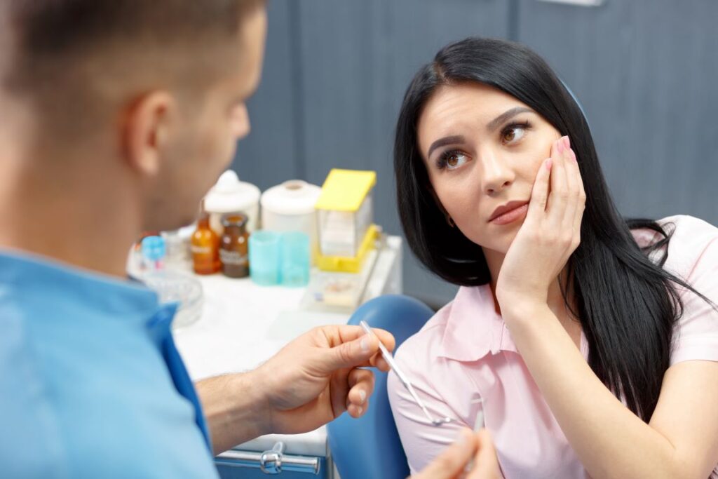 A woman with a toothache in a dental chair